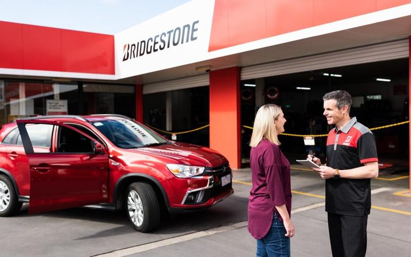 Bridgestone technician handing car keys to customer