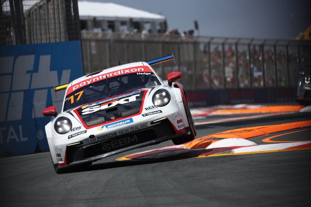 Callum Hedge racing Porsche Carrera Cup car over chicane