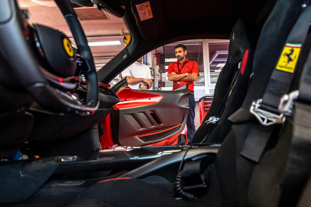 Man standing outside of Ferrari SF90 XX Stradale