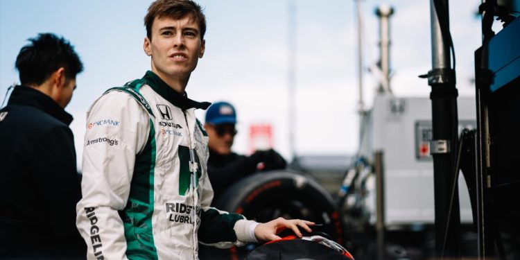 Marcus Armstrong standing in IndyCar pitlane