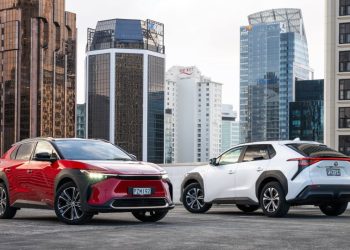 Two Toyota bZ4X EVs parked on roof top in city