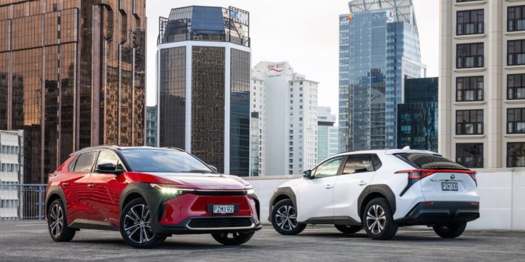 Two Toyota bZ4X EVs parked on roof top in city