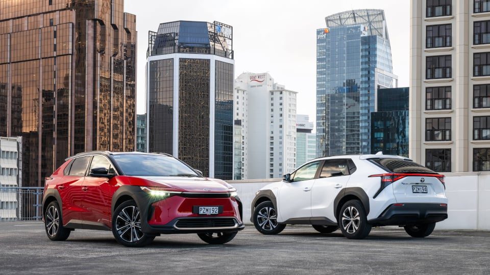 Two Toyota bZ4X EVs parked on roof top in city