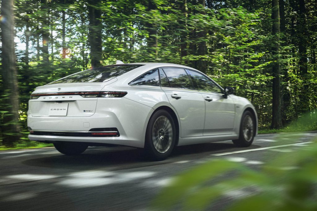 Toyota Crown Sedan driving through forest