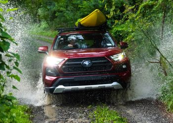 Toyota RAV4 Hybrid driving through river in bush