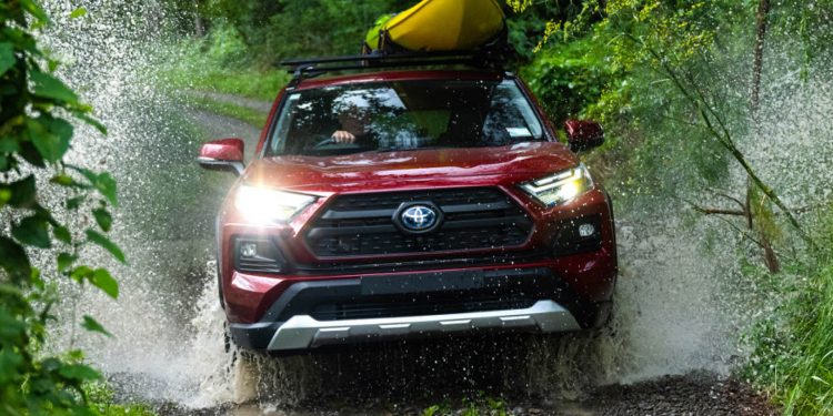 Toyota RAV4 Hybrid driving through river in bush