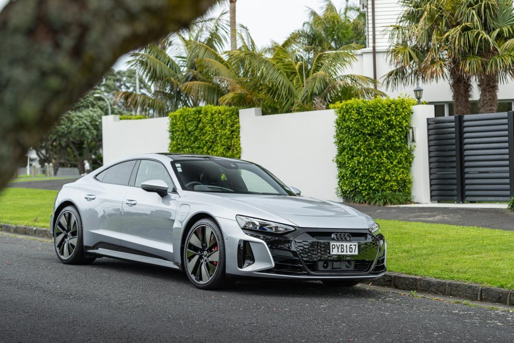 Audi RS e-tron GT front quarter shot, in front of a nice house