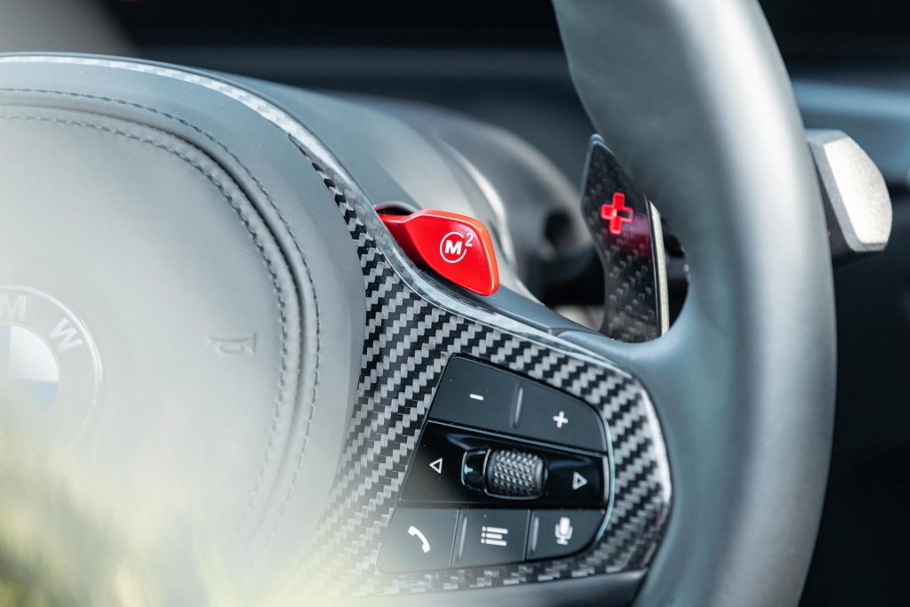 M2 button on the carbon fibre steering wheel of the BMW M2