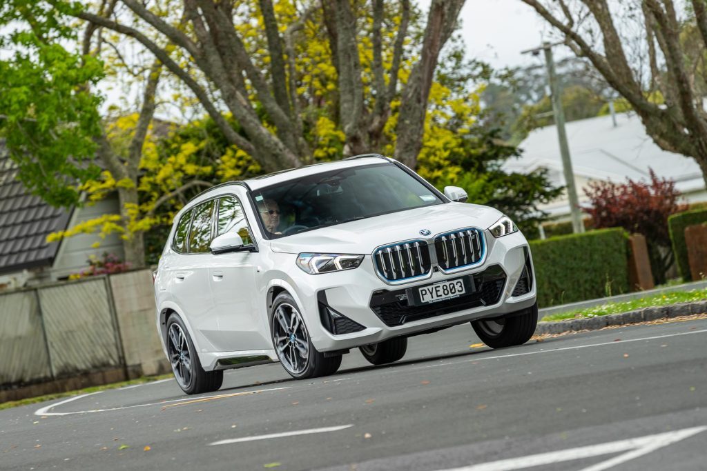 Cornering shot of a white BMW iX1 xDrive30