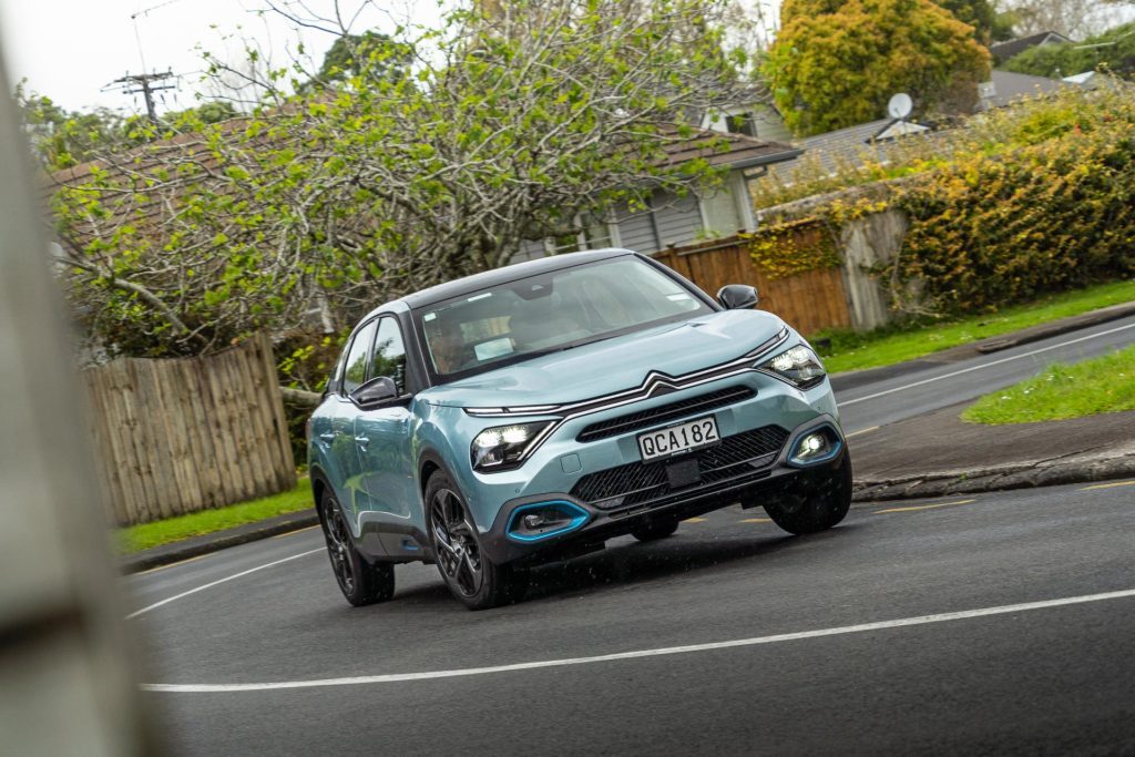 Citroen e-C4 Shine taking a corner in a residential area