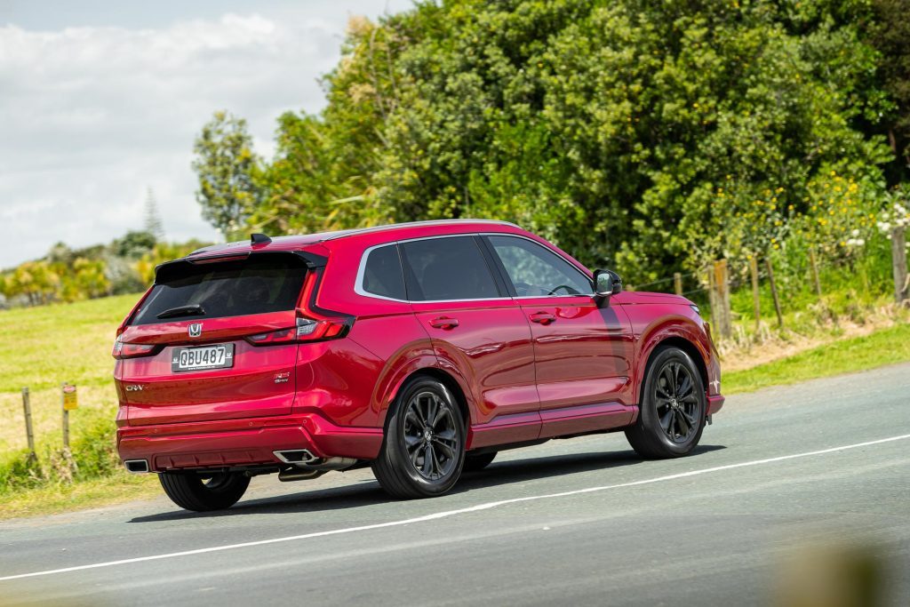 Red Honda CR-V RS taking a corner, shown from behind