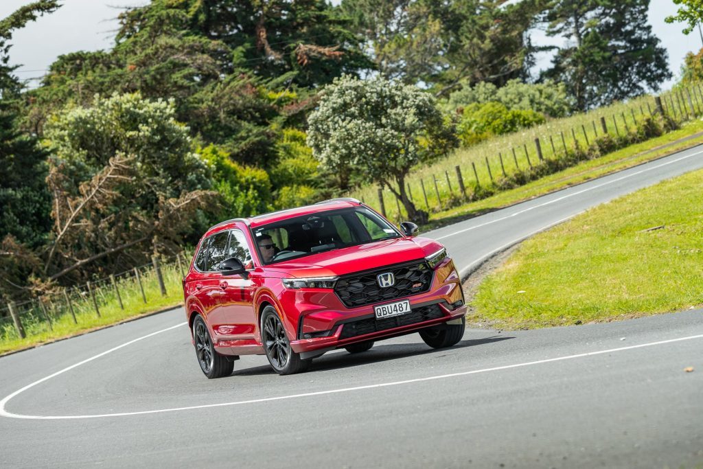 Honda CR-V RS taking a corner, in red, shown from the front quarter angle