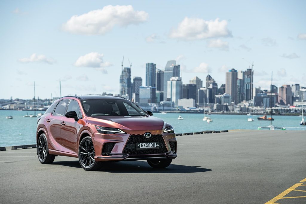 Front quarter of Lexus RX 500h with Auckland city behind