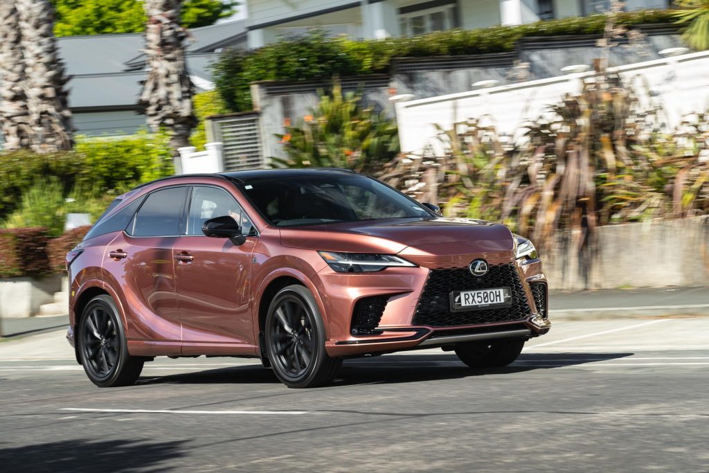 Moving shot of the Lexus RX 500h F Sport in residential setting