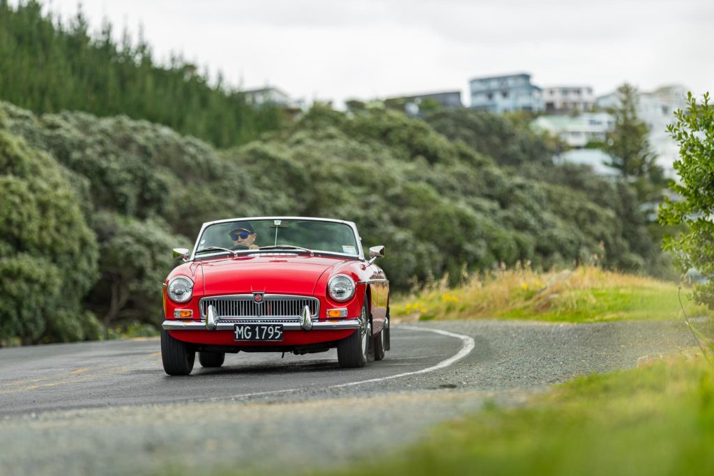 MG MGB Roadster front view, driving on a shorefront road