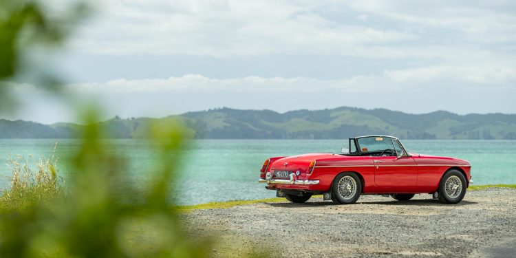 1965 MGB parked on a New Zealand shorefront, showing rear
