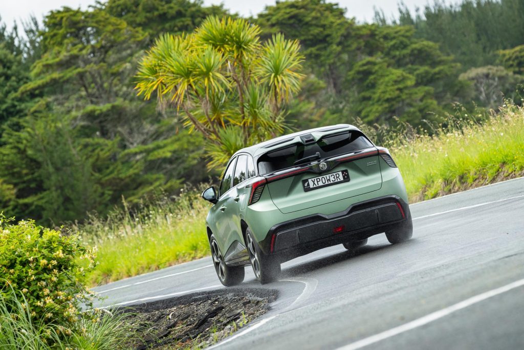 MG4 XPower taking a corner in the wet, shown from the rear