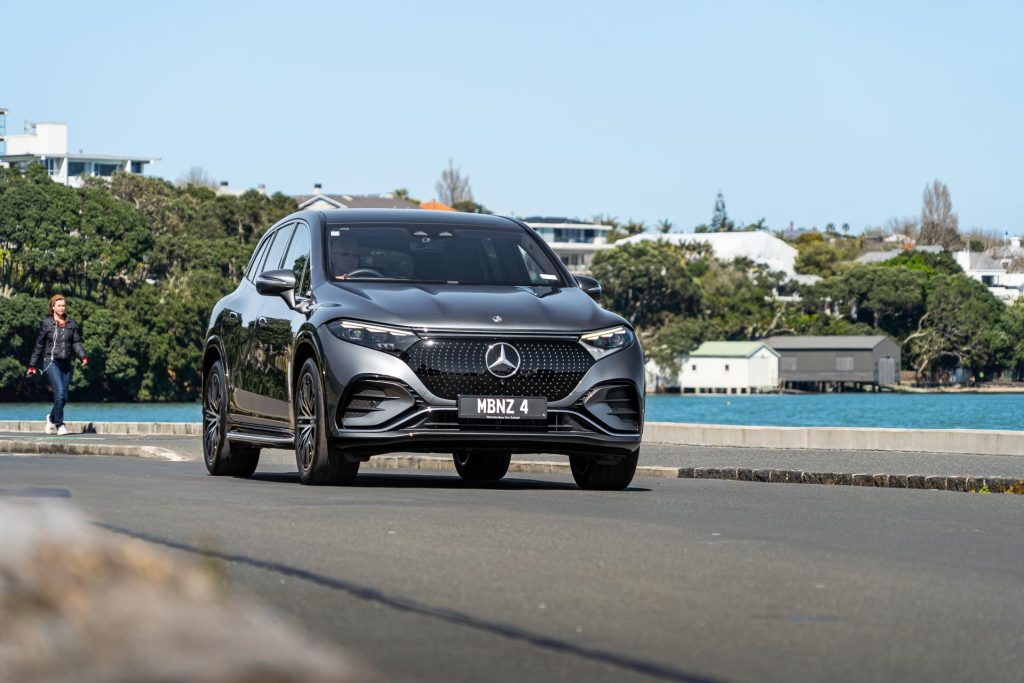 Mercedes-Benz EQS 450 driving on the waterfront