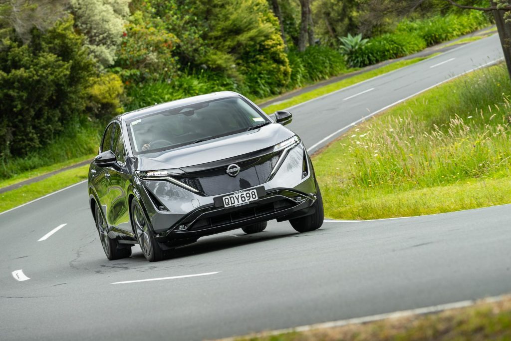 Nissan Ariya in grey, taking a corner