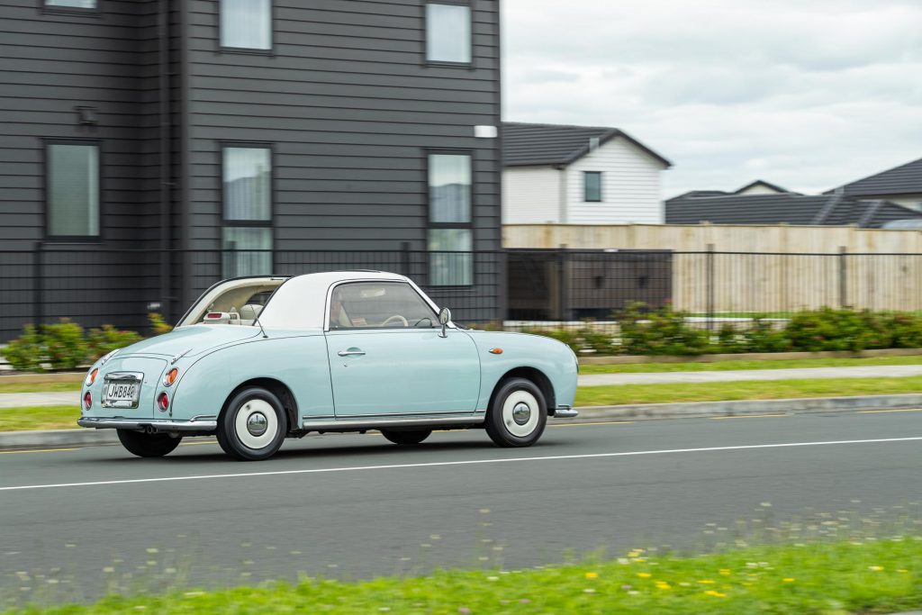 Nissan Figaro driving with the roof off
