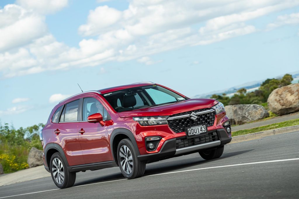 The Suzuki S-Cross Hybrid in red taking a corner at pace