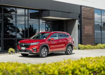 Suzuki S-Cross Hybrid in red, parked outside an office building