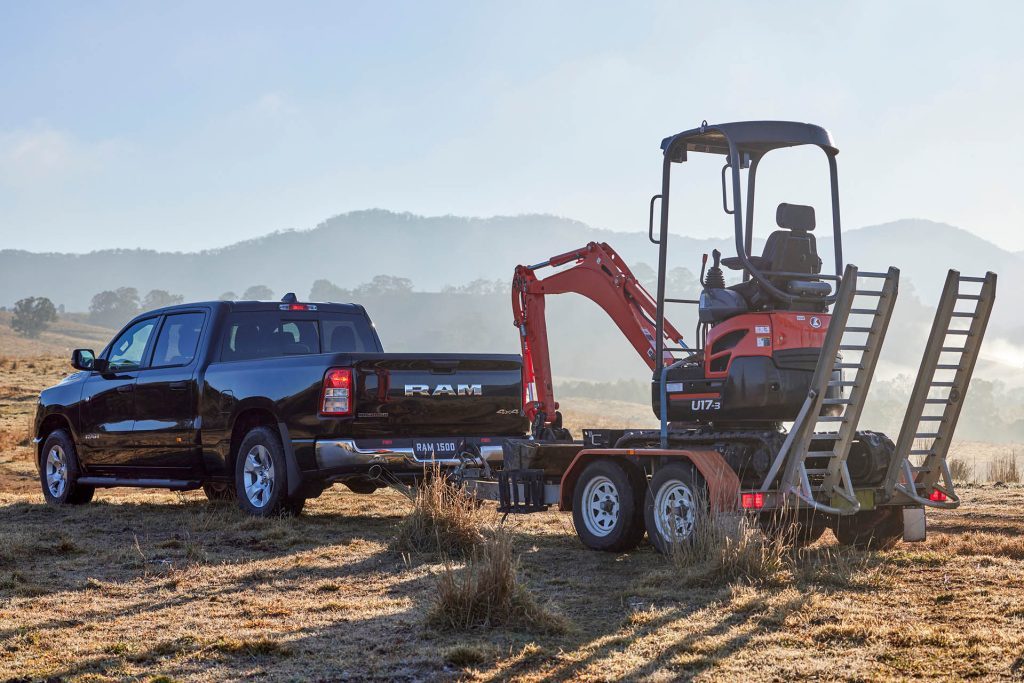 RAM 1500 Big Horn towing digger on trailer