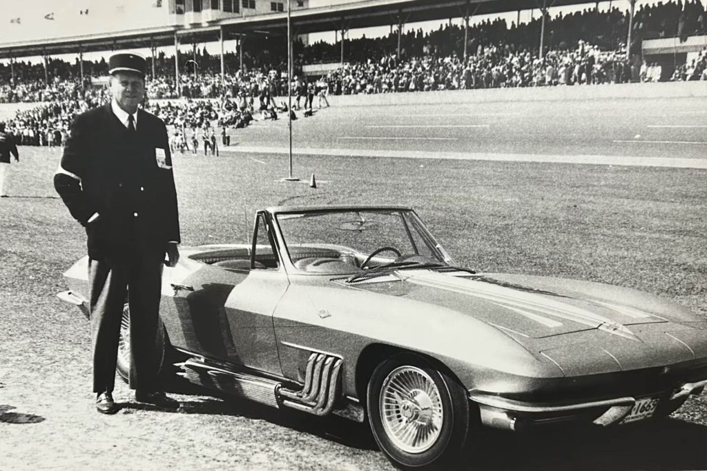 Harley Earl standing next to 1963 Chevrolet Corvette Styling Car at Daytona 500