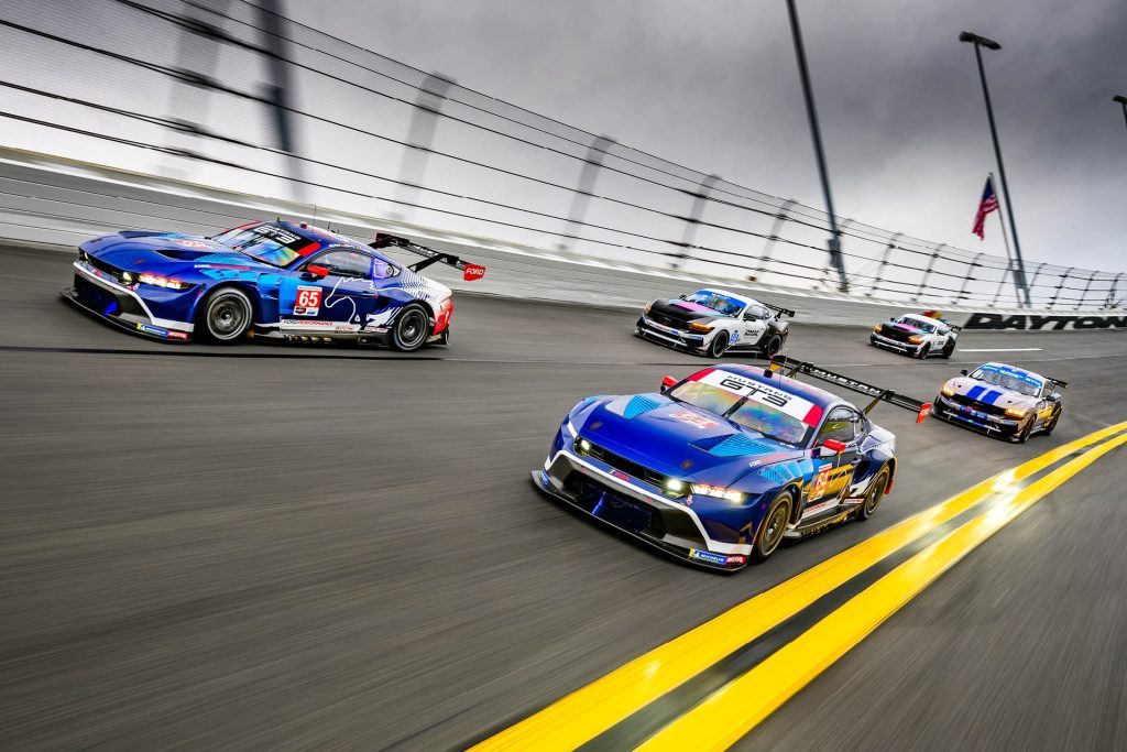 2024 Ford Mustang GT3 and GT4 cars driving on banked oval at Daytona