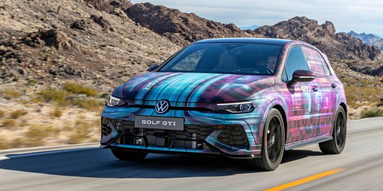 2024 Volkswagen Golf GTI driving on road in desert