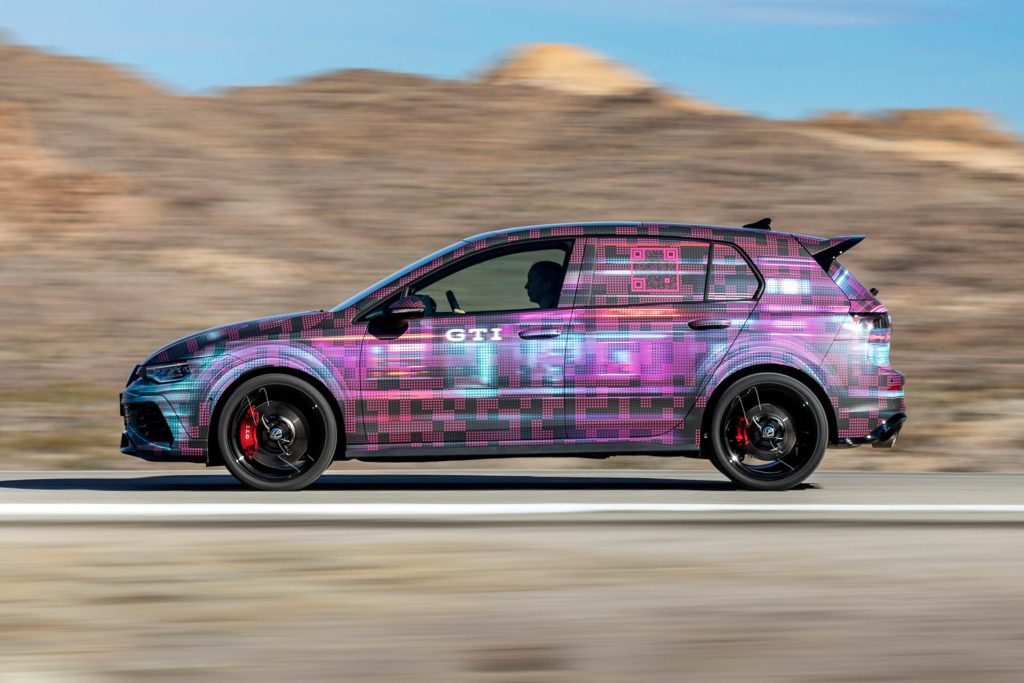 2024 Volkswagen Golf GTI driving on road in desert