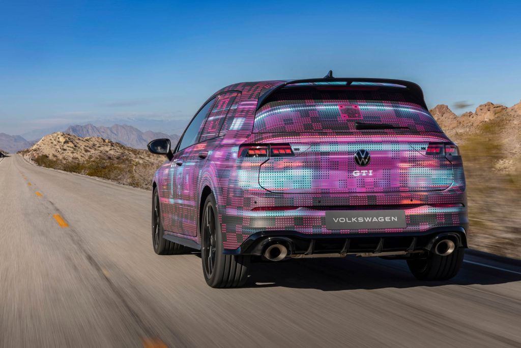 2024 Volkswagen Golf GTI driving on road in desert