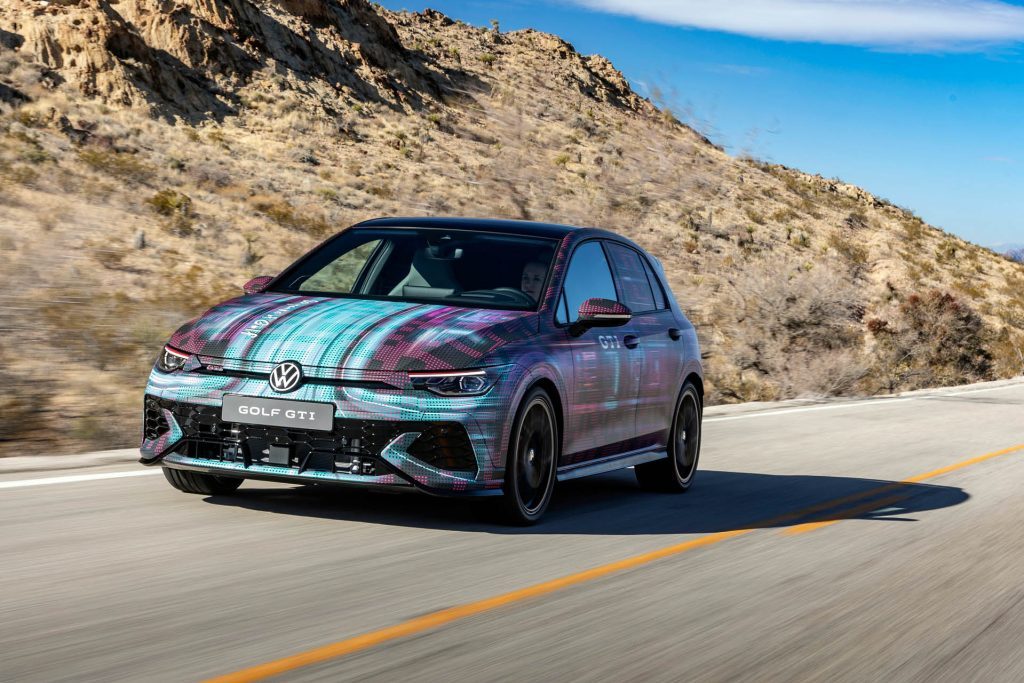 2024 Volkswagen Golf GTI in camouflage driving on road