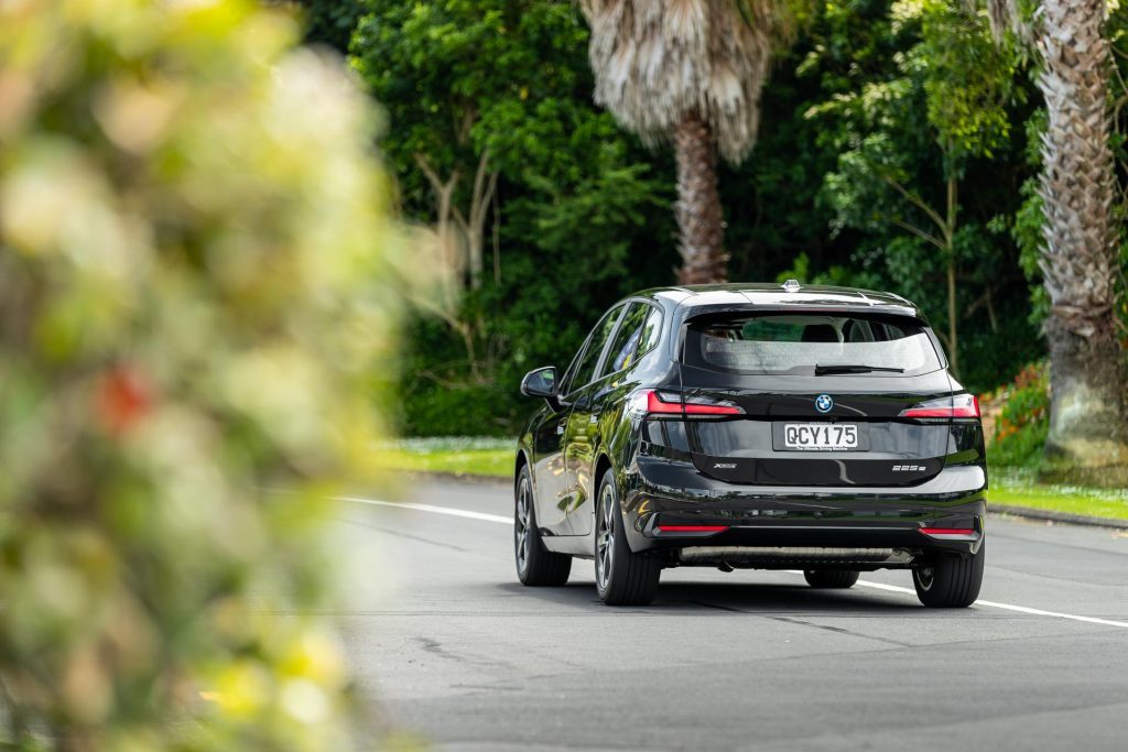 BMW 225e Active Tourer rear driving shot, in black