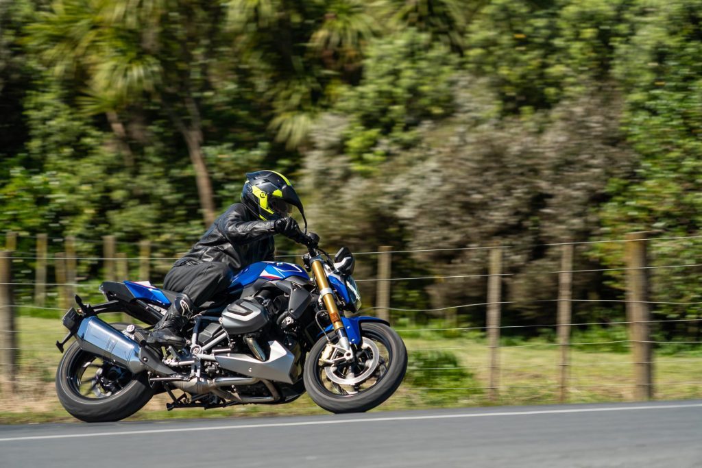 BMW R 1250 R Roadster leaning over into a corner, pictured in blue
