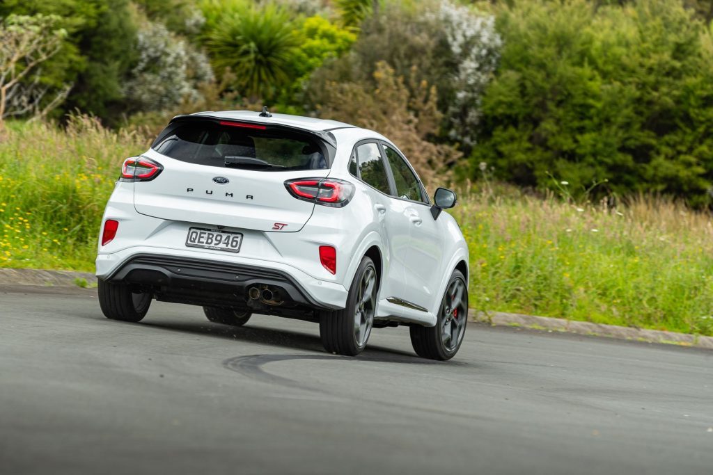 Ford Puma ST taking a corner at pace, from the rear