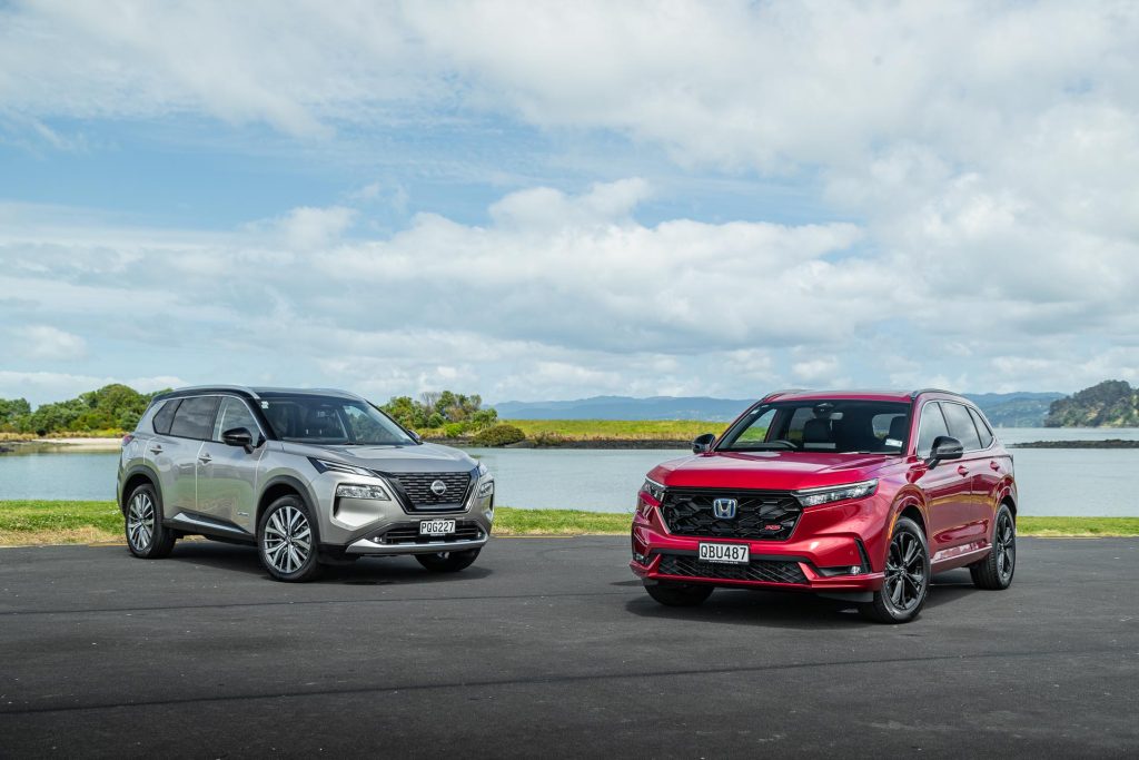 Honda CR-V in red parked next to a Nissan X-Trail