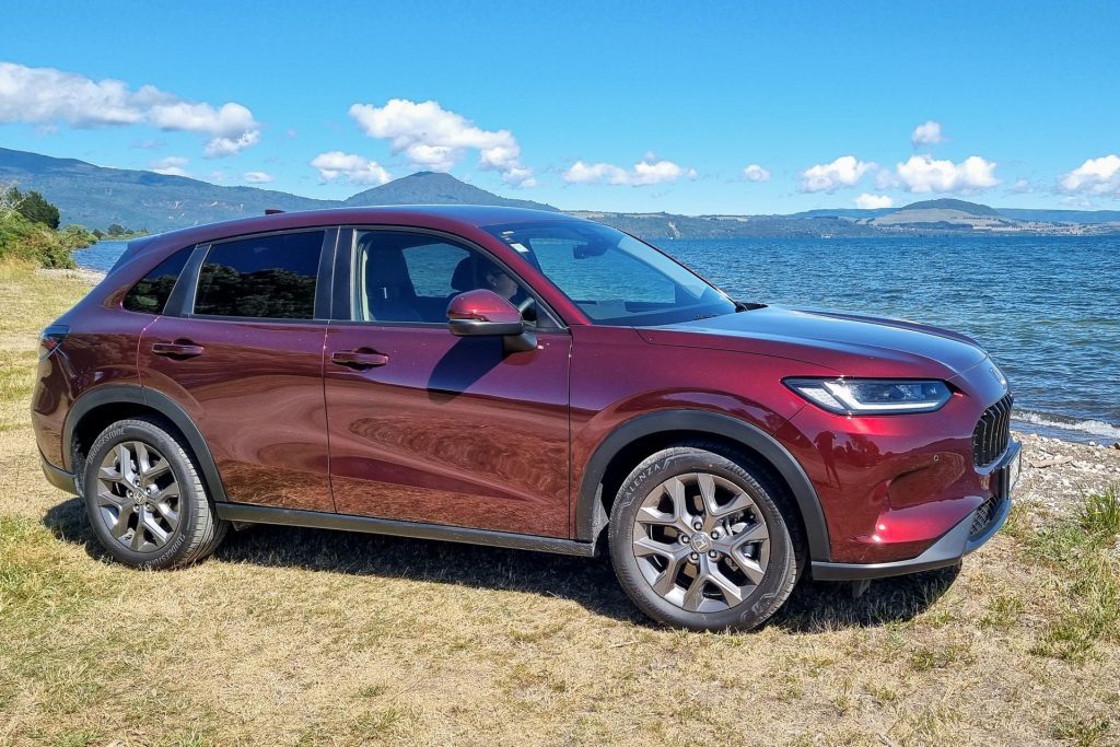 Honda ZR-V turbo in red parked next to a lake