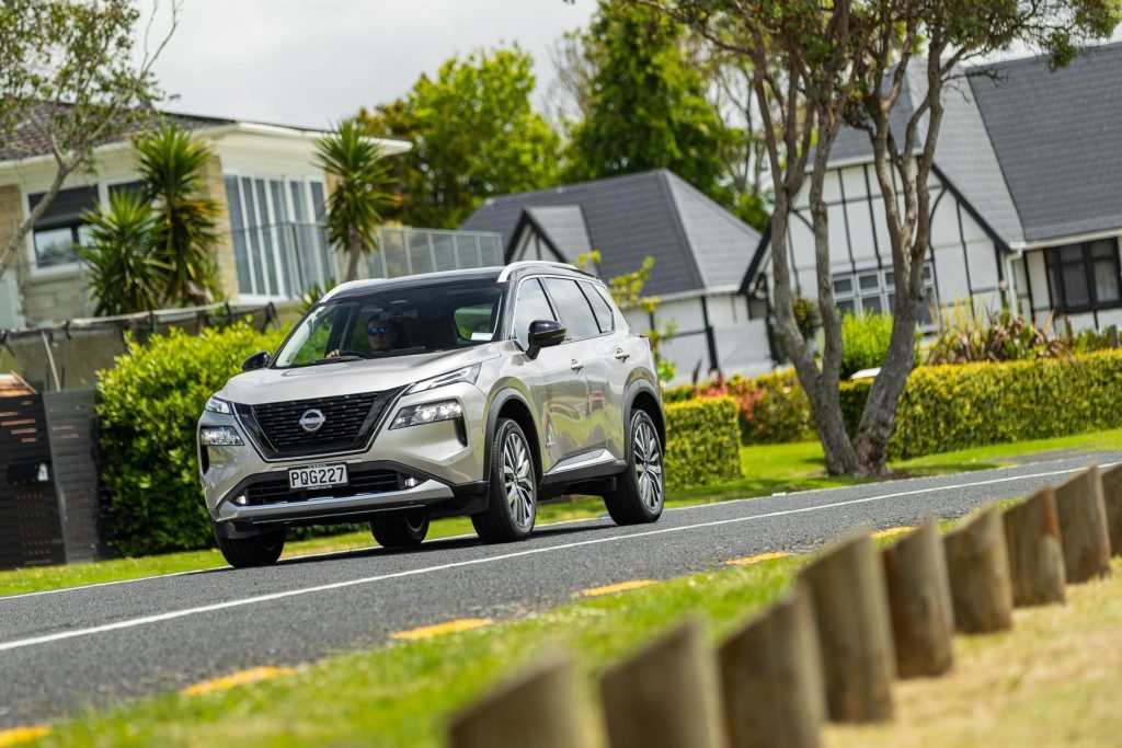 Nissan X-Trail e-Power Ti-L driving in a suburban space