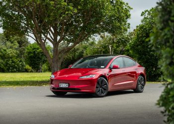 Tesla Model 3 RWD facelift front quarter angle, in red