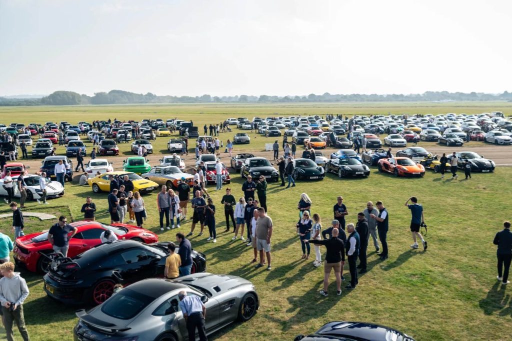 Supercars parked on grass at Collecting Cars Coffee Run in UK