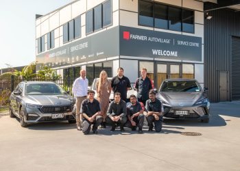 Farmer Autovillage team standing in front of cars