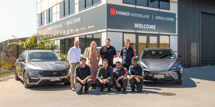 Farmer Autovillage team standing in front of cars