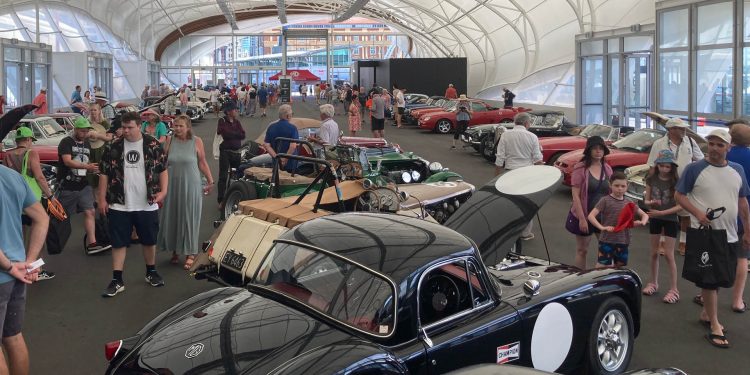 Crowd gathering around collection of MG cars at Centennial Celebration in Auckland