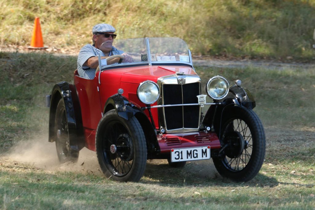 MG M driving around corner on grass circuit