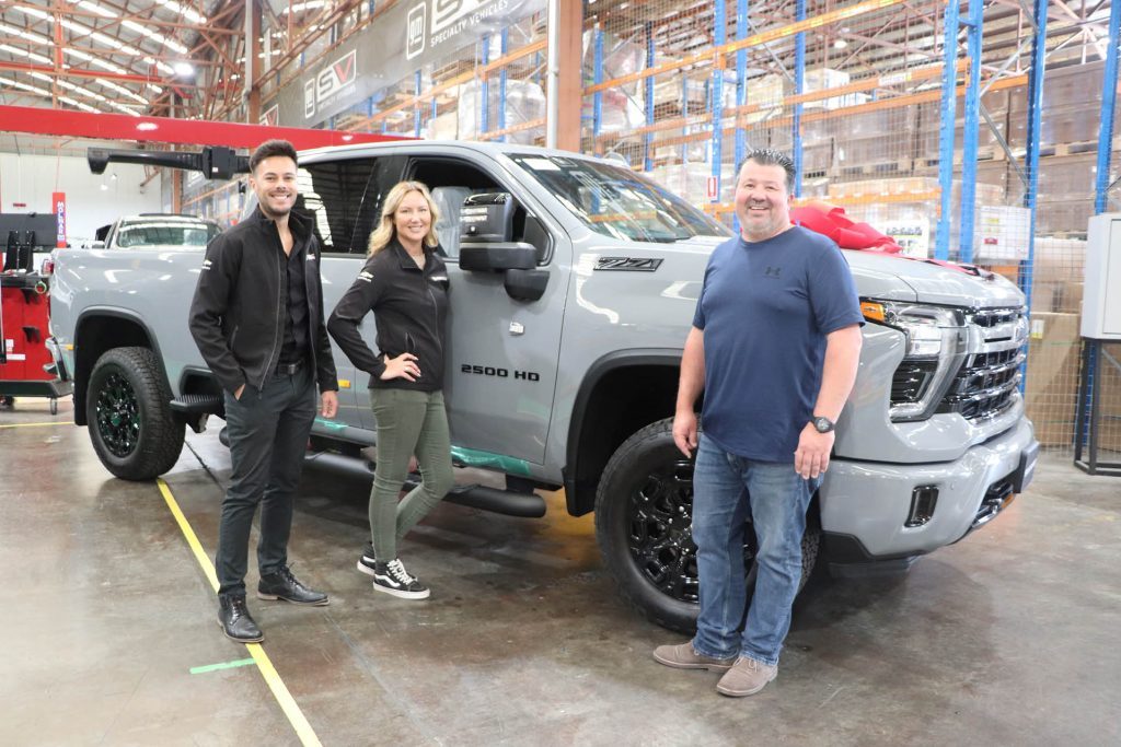 Owner standing next to 10,000th remanufactured Chevrolet Silverado