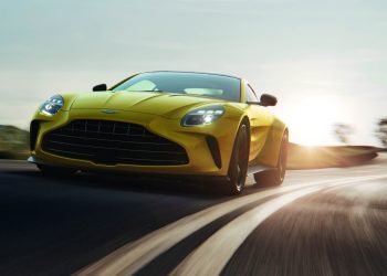 2024 Aston Martin Vantage driving on road at sunset