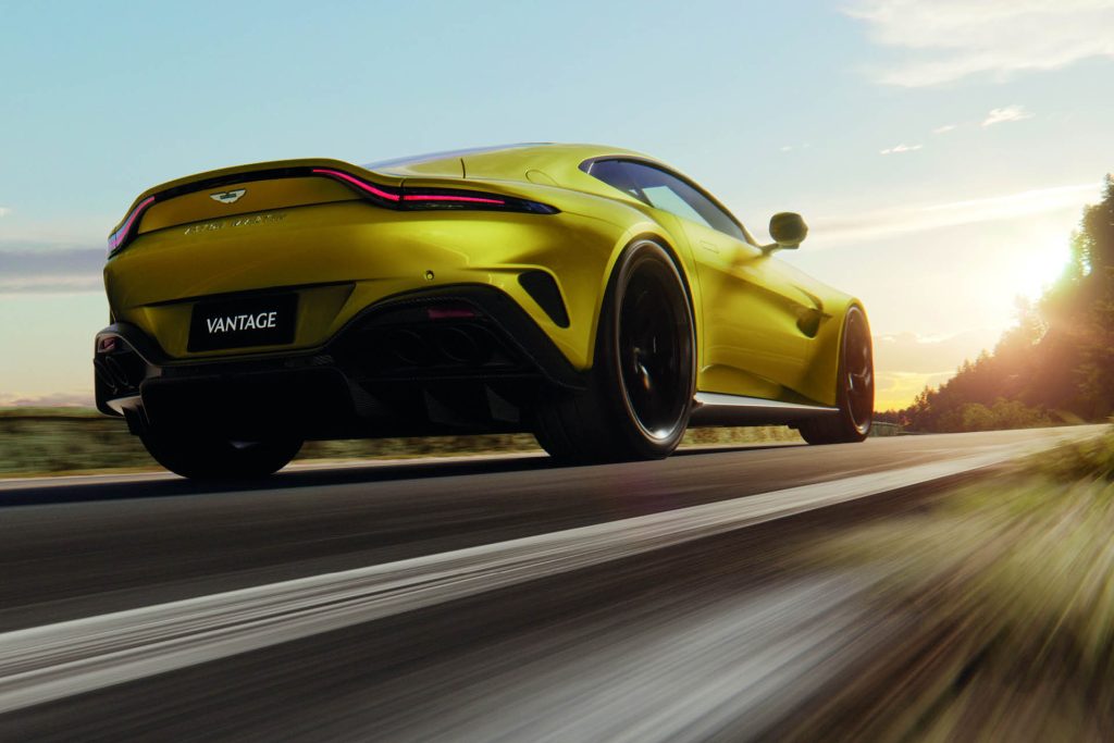 2024 Aston Martin Vantage driving on road at sunset