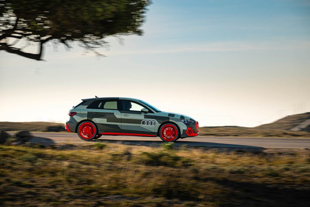 2025 Audi S3 facelift in camouflage driving past tree