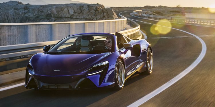 2025 McLaren Artura Spider driving on road at sunset